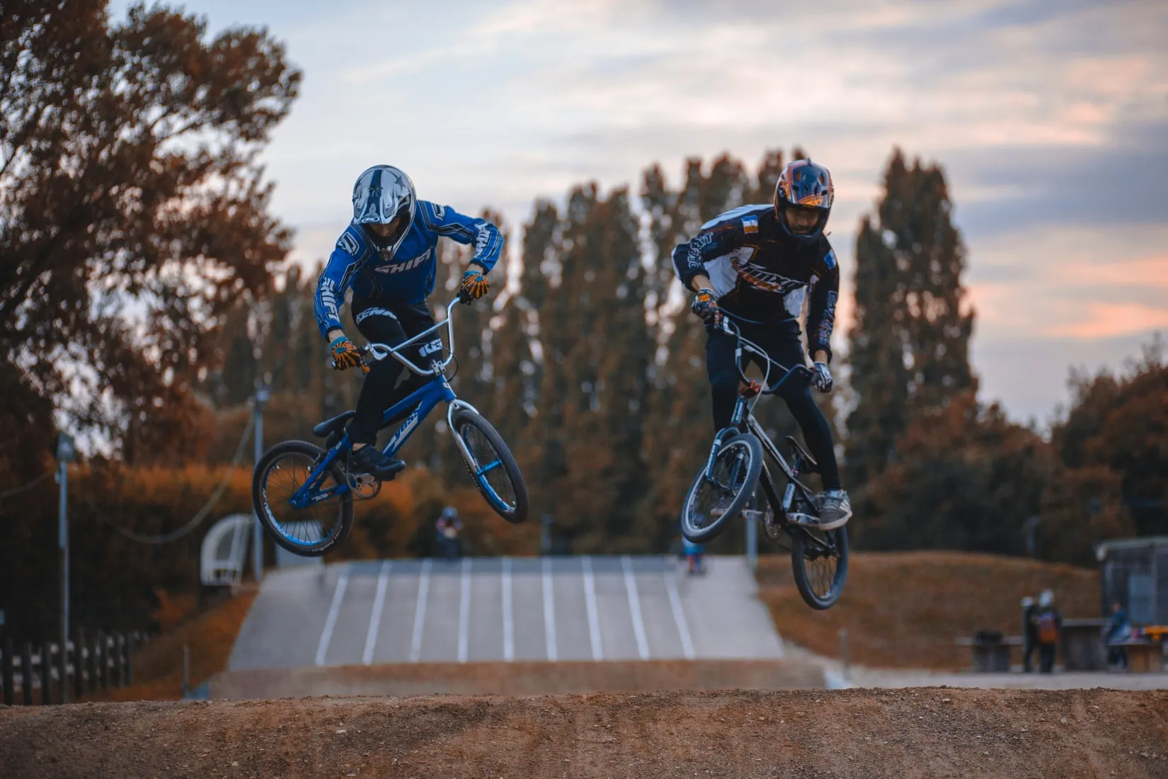 Extreme Sport Activities - two tourists doing a BMX jump from a springboard