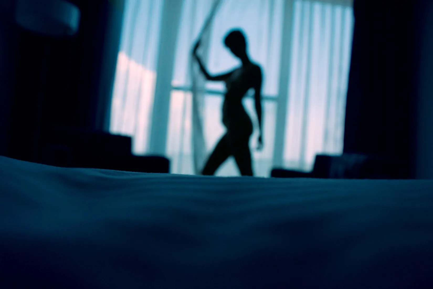 Silhouette of a woman dancer against a window background